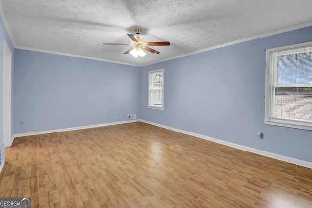 unfurnished room featuring ornamental molding, light hardwood / wood-style floors, and a textured ceiling