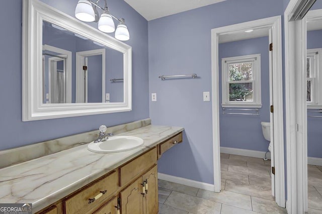 bathroom with vanity, toilet, and tile patterned flooring