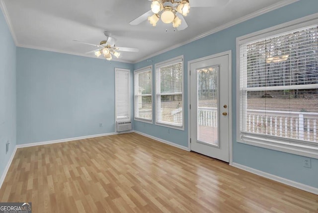 empty room with crown molding, a wall unit AC, light hardwood / wood-style floors, and ceiling fan