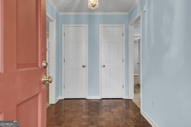 entrance foyer featuring crown molding and dark parquet flooring