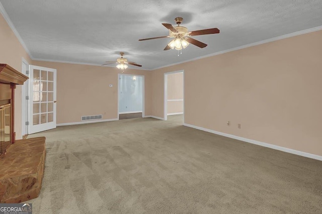 unfurnished living room with ceiling fan, light colored carpet, ornamental molding, and a brick fireplace