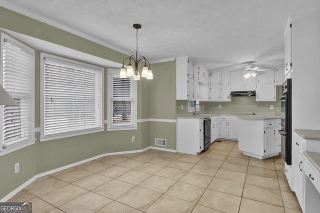 kitchen featuring ceiling fan with notable chandelier, white cabinetry, sink, hanging light fixtures, and black appliances