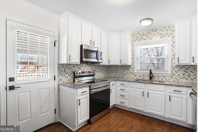 kitchen featuring sink, stainless steel appliances, and white cabinets