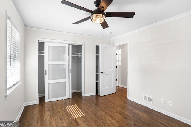 unfurnished bedroom featuring ornamental molding, dark hardwood / wood-style floors, ceiling fan, and a closet