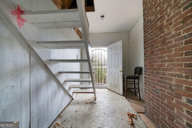 basement featuring brick wall