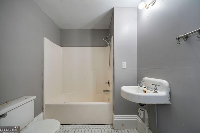 full bathroom with sink, shower / tub combination, and toilet