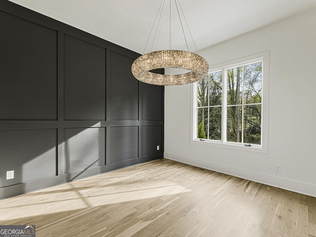 unfurnished dining area with light hardwood / wood-style flooring and a healthy amount of sunlight