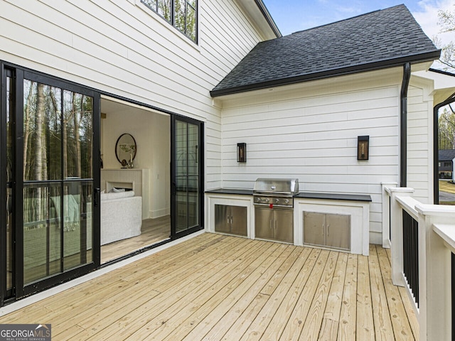 deck with a grill and exterior kitchen