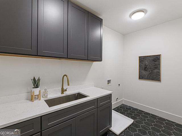 washroom featuring cabinets, electric dryer hookup, sink, and washer hookup