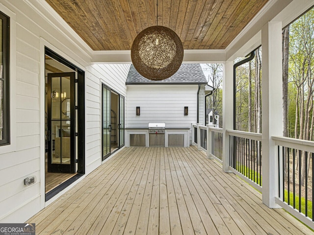 wooden deck featuring area for grilling and a grill