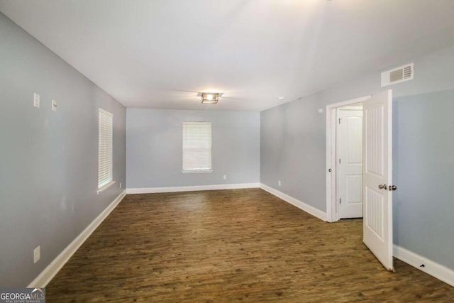 empty room featuring dark wood-type flooring