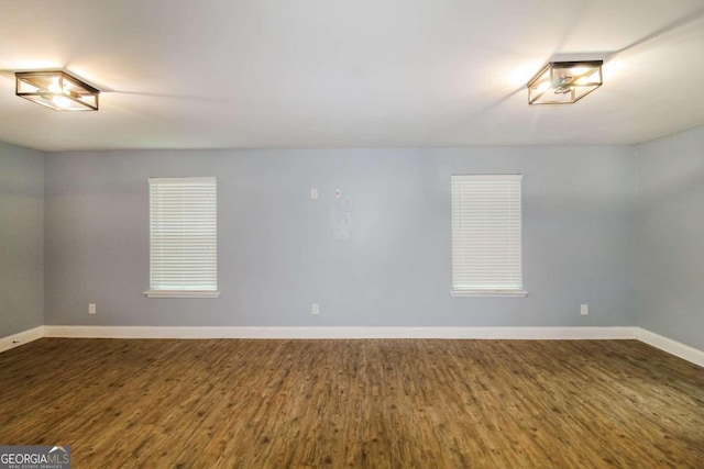 spare room featuring dark wood-type flooring