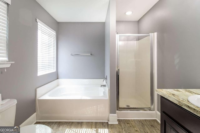 full bathroom featuring vanity, toilet, separate shower and tub, and hardwood / wood-style floors