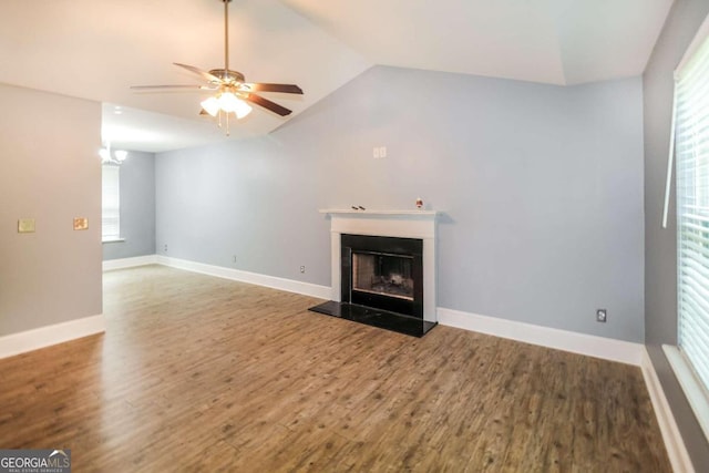 unfurnished living room featuring hardwood / wood-style flooring, vaulted ceiling, and ceiling fan