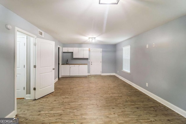 unfurnished living room with wood-type flooring