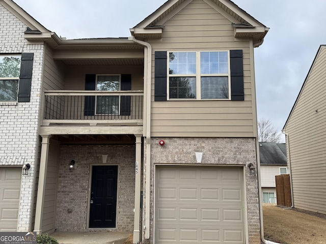 view of property with a balcony and a garage