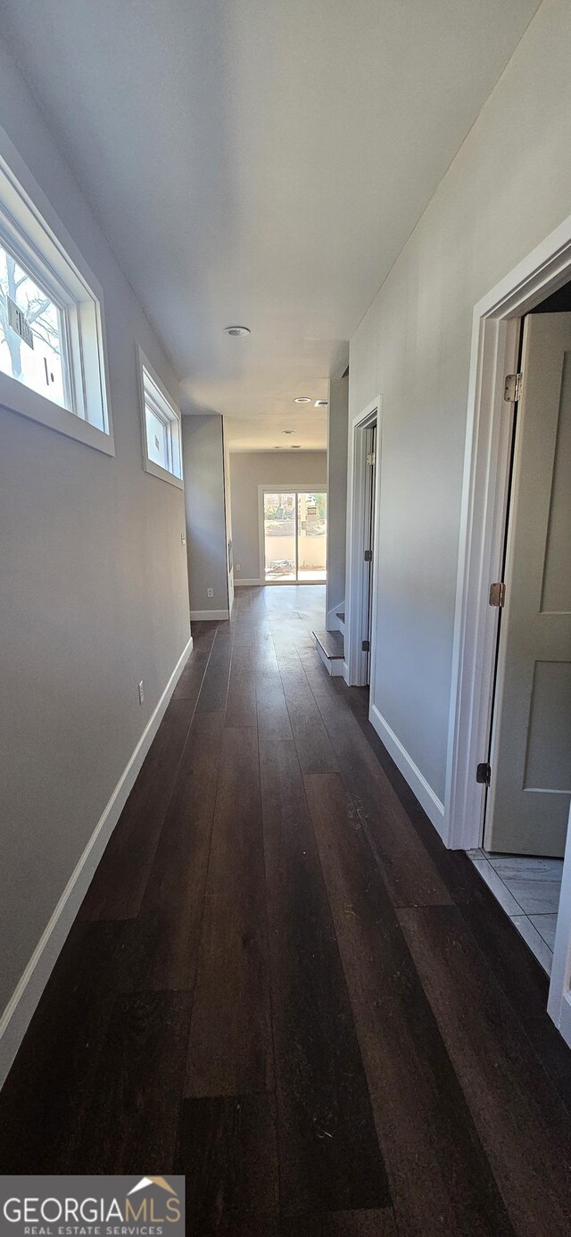 hallway featuring dark hardwood / wood-style flooring