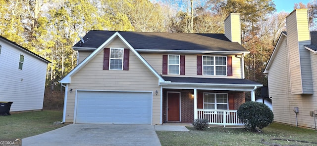 view of front facade featuring a garage, a porch, and a front yard