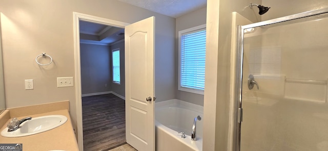 bathroom featuring vanity, wood-type flooring, ornamental molding, and independent shower and bath