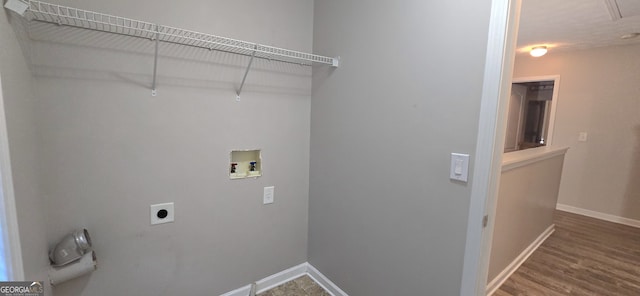 clothes washing area with hardwood / wood-style flooring, washer hookup, and electric dryer hookup