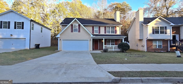 view of front of property with a garage, a front yard, and a porch