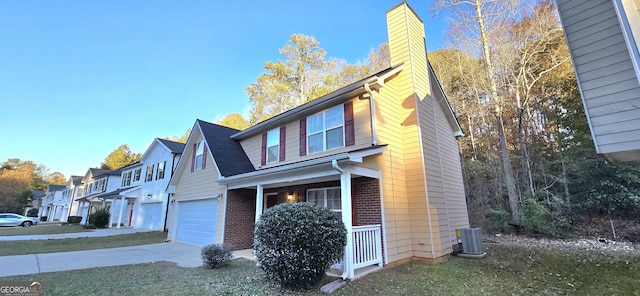 view of side of home with a garage, central AC, and a porch