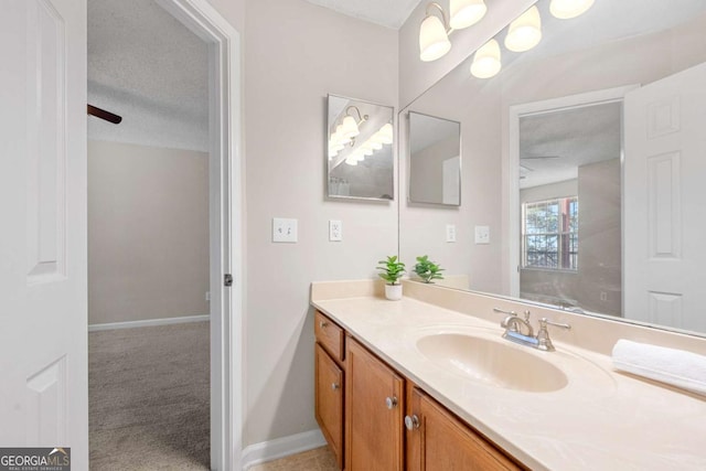 bathroom with vanity and a textured ceiling