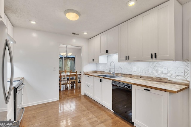 5833 Westerling Pl, Powder Springs, GA 30127 - kitchen with stainless steel appliances, butcher block countertops, a sink, a chandelier, and backsplash