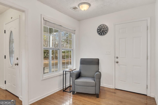 5833 Westerling Pl, Powder Springs, GA 30127 - sitting room with light wood-type flooring, a textured ceiling, and baseboards