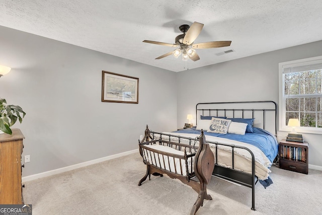 5833 Westerling Pl, Powder Springs, GA 30127 - carpeted bedroom with baseboards, a textured ceiling, and a ceiling fan