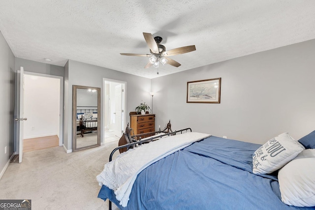 5833 Westerling Pl, Powder Springs, GA 30127 - bedroom with light colored carpet, a textured ceiling, baseboards, ensuite bathroom, and ceiling fan