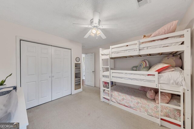 5833 Westerling Pl, Powder Springs, GA 30127 - bedroom featuring carpet flooring, a closet, a ceiling fan, and a textured ceiling