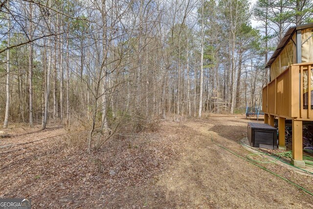 5833 Westerling Pl, Powder Springs, GA 30127 - view of yard featuring a trampoline and a deck