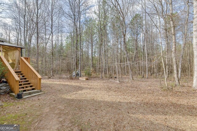 5833 Westerling Pl, Powder Springs, GA 30127 - view of yard with stairway and a view of trees