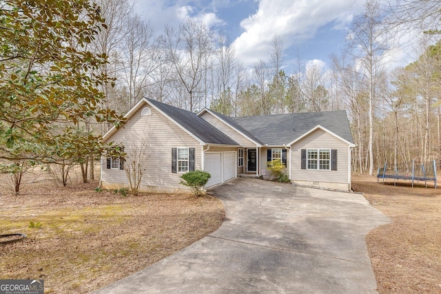 5833 Westerling Pl, Powder Springs, GA 30127 - ranch-style house with a trampoline, concrete driveway, and a garage