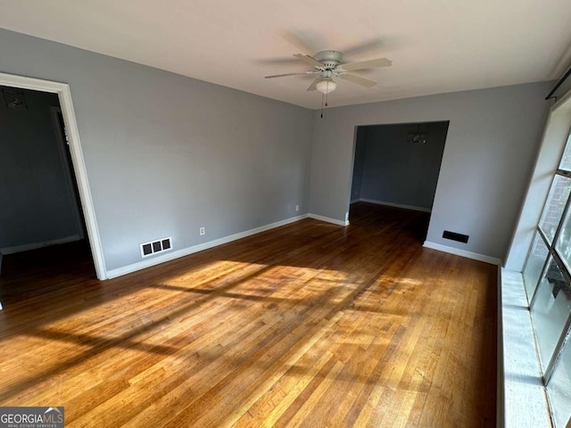 empty room featuring hardwood / wood-style flooring and ceiling fan