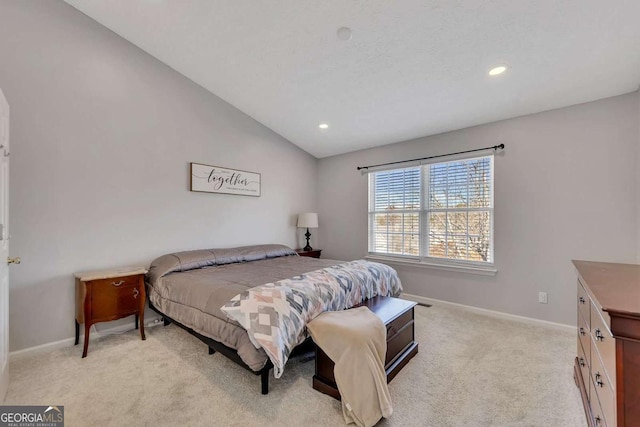 bedroom with vaulted ceiling and light carpet