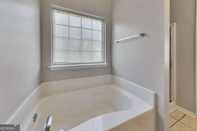 bathroom featuring tile patterned floors and a bathtub