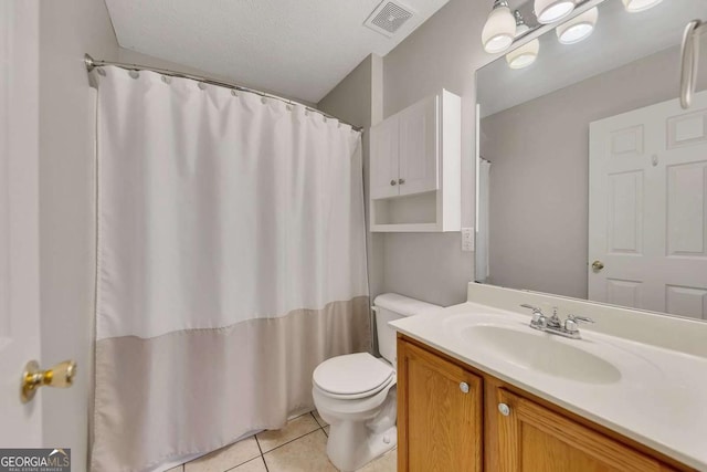 bathroom with vanity, tile patterned floors, and toilet