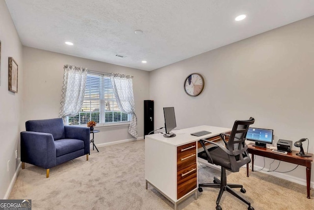 office area featuring light colored carpet and a textured ceiling