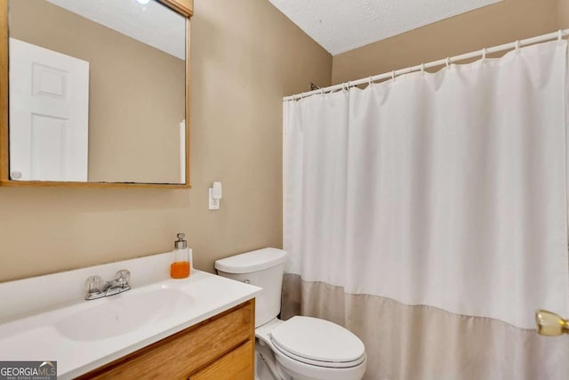 bathroom with vanity, a textured ceiling, and toilet