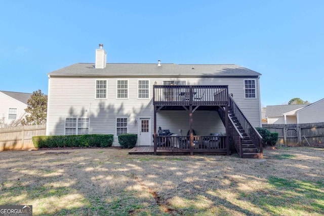 rear view of property featuring a deck