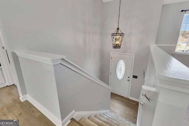 entrance foyer with a notable chandelier and light hardwood / wood-style flooring