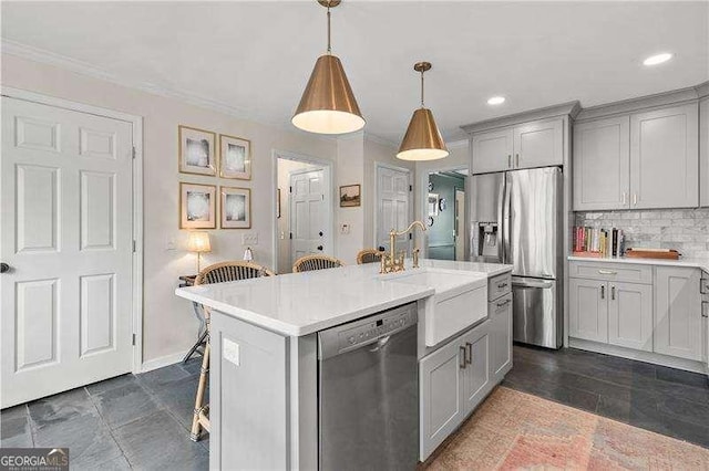 kitchen with gray cabinets, a breakfast bar, hanging light fixtures, stainless steel appliances, and a center island with sink