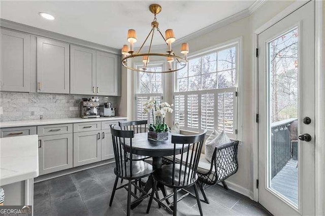 dining area featuring an inviting chandelier and ornamental molding