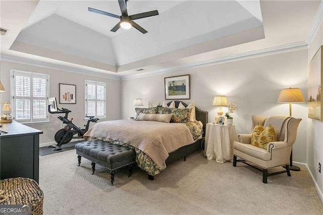 bedroom featuring crown molding, light colored carpet, a raised ceiling, and ceiling fan