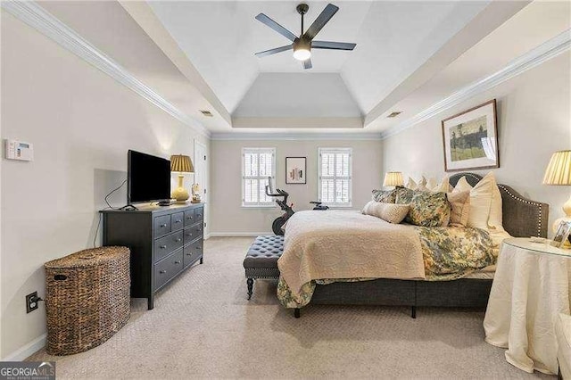 bedroom with ornamental molding, light colored carpet, ceiling fan, and a tray ceiling