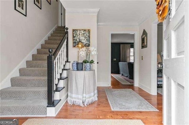 entrance foyer with wood-type flooring and ornamental molding