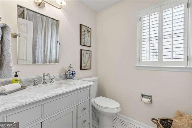 bathroom featuring vanity and toilet