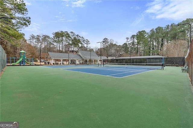 view of sport court with a playground